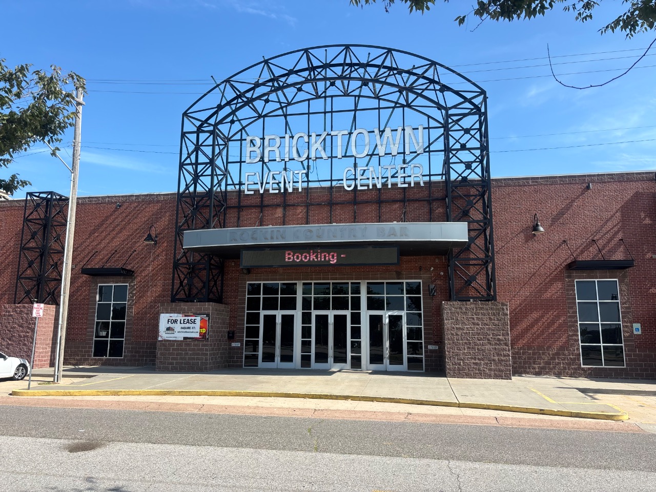 Brick exterior of Bricktown Event Center with the steel marquee arch over the entrance